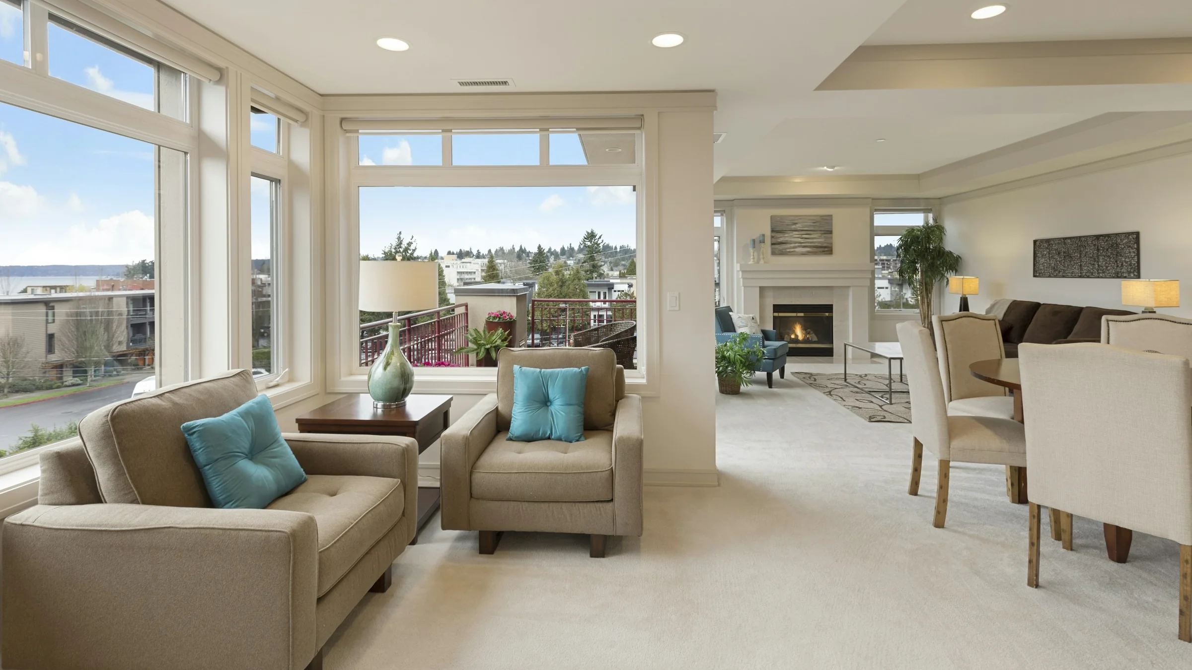 A bright, freshly painted open-plan living room with large windows